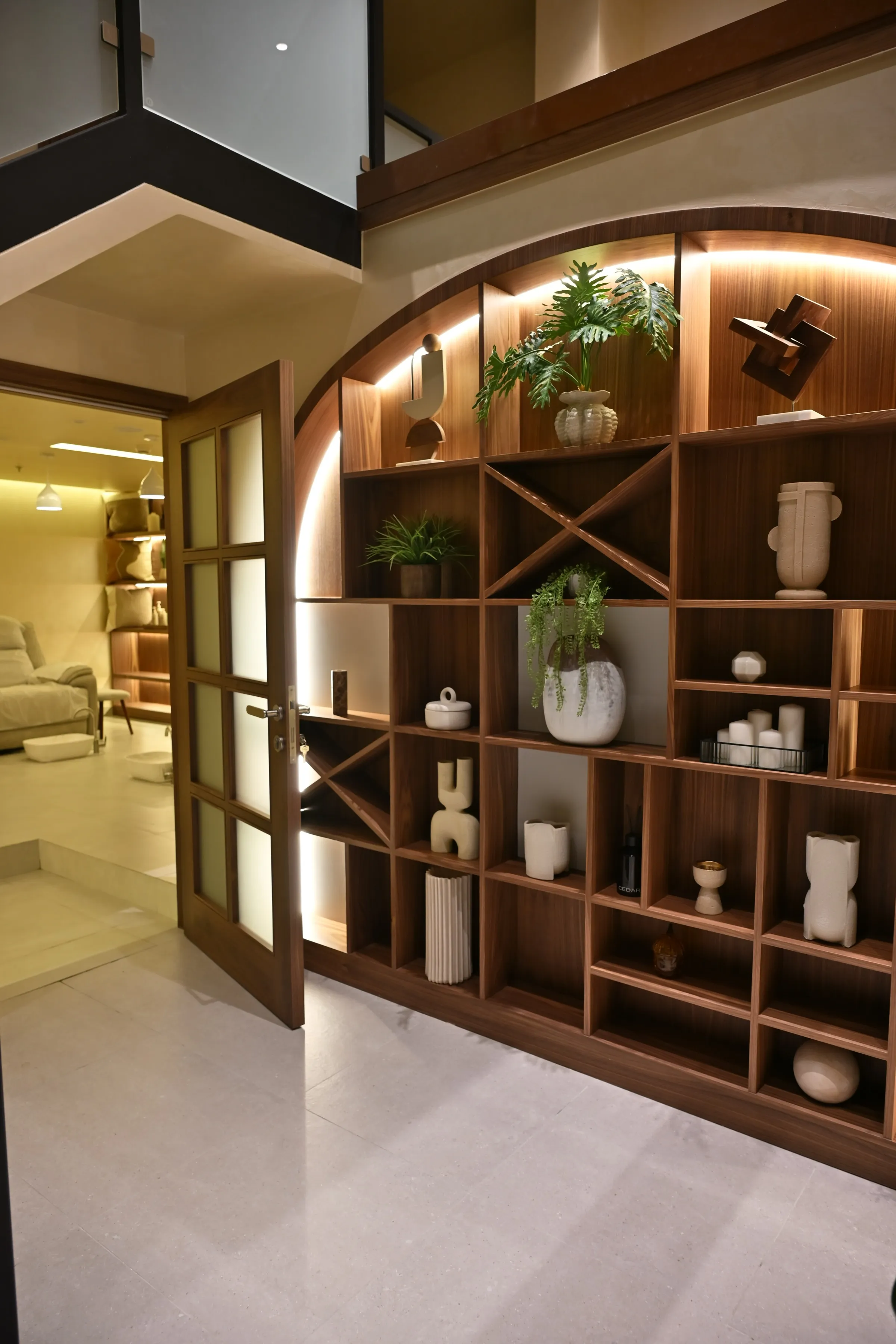 Walnut arched display shelving at the entrance