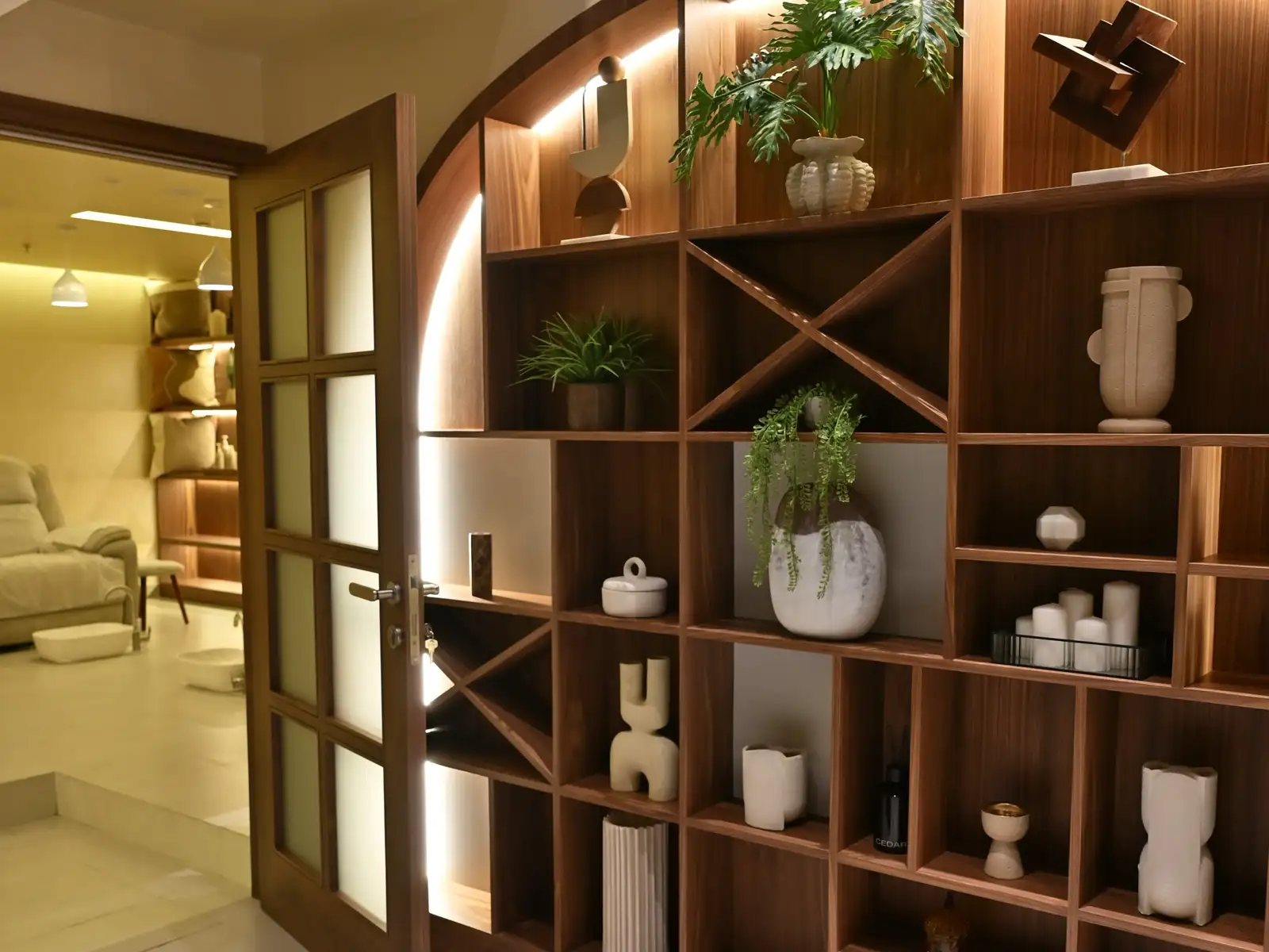 Walnut arched shelving at the Rahmania Men’s entrance, treatment lounge beyond the open door
