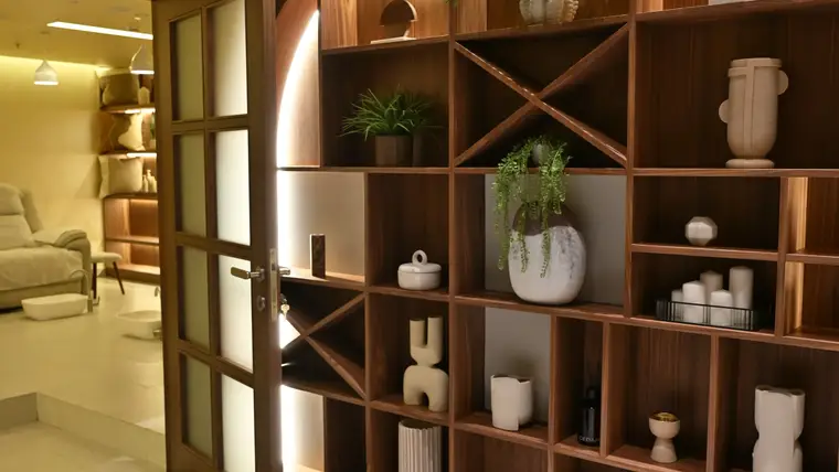 Walnut arched shelving at the Rahmania Men’s entrance, treatment lounge beyond the open door