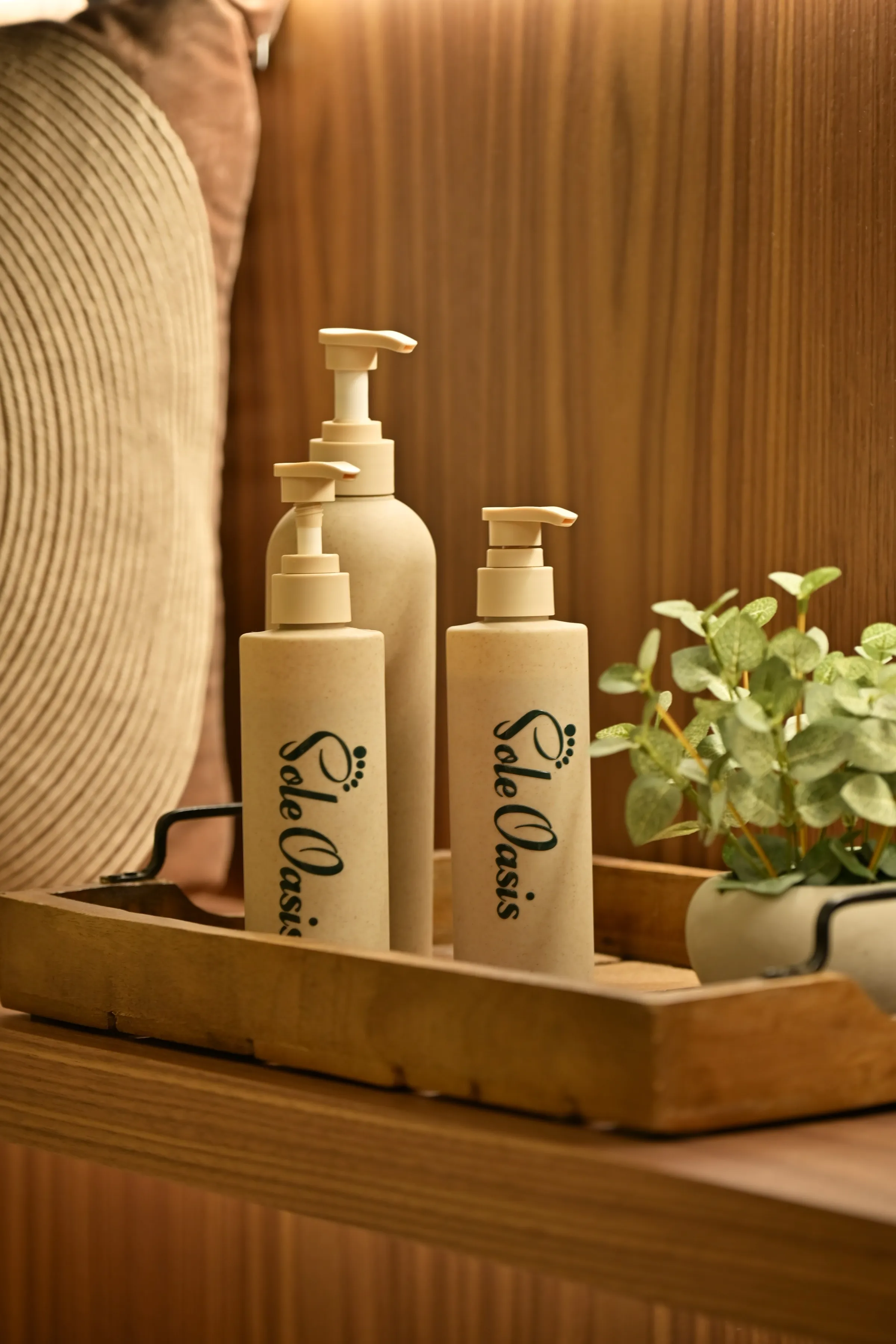 Sole Oasis branded oils and products staged on a wooden tray